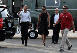 President Barack Obama and first lady Michelle Obama walk over to greet people after arriving at Vineyard Haven on Martha's Vineyard, Mass., Friday, Aug. 7, 2015. The president is returning to his summer vacation spot of choice, the Massachusetts island of Martha's Vineyard, for more than two weeks of hoped-for rest coupled with extended pursuit of his favorite leisure sport: golf. (AP Photo/Susan Walsh)
