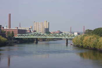 Lowell on the Merrimack River with Cox Bridge. (Wikipedia)